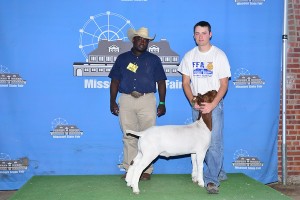 Photo Courtesy of Missouri State Fair: Spencer Scotten, 21, of Nevada, received Champion Overall and FFA Champion in the FFA Wether Goat Show at the 2014 Missouri State Fair on August 11. Spencer is the son of Shannon and Krista Scotten and is a member of the Nevada FFA Chapter. Pictured with Spencer is Judge Brandon Callis.