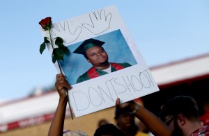 FERGUSON, MO - AUGUST 17: A demonstrator holds a sign reading, "Dont Shoot", with a picture of Michael Brown on August 17, 2014 in Ferguson, Missouri. Violent outbreaks have taken place in Ferguson since the shooting death of Michael Brown by a Ferguson police officer on August 9th. (Photo by Joe Raedle/Getty Images)